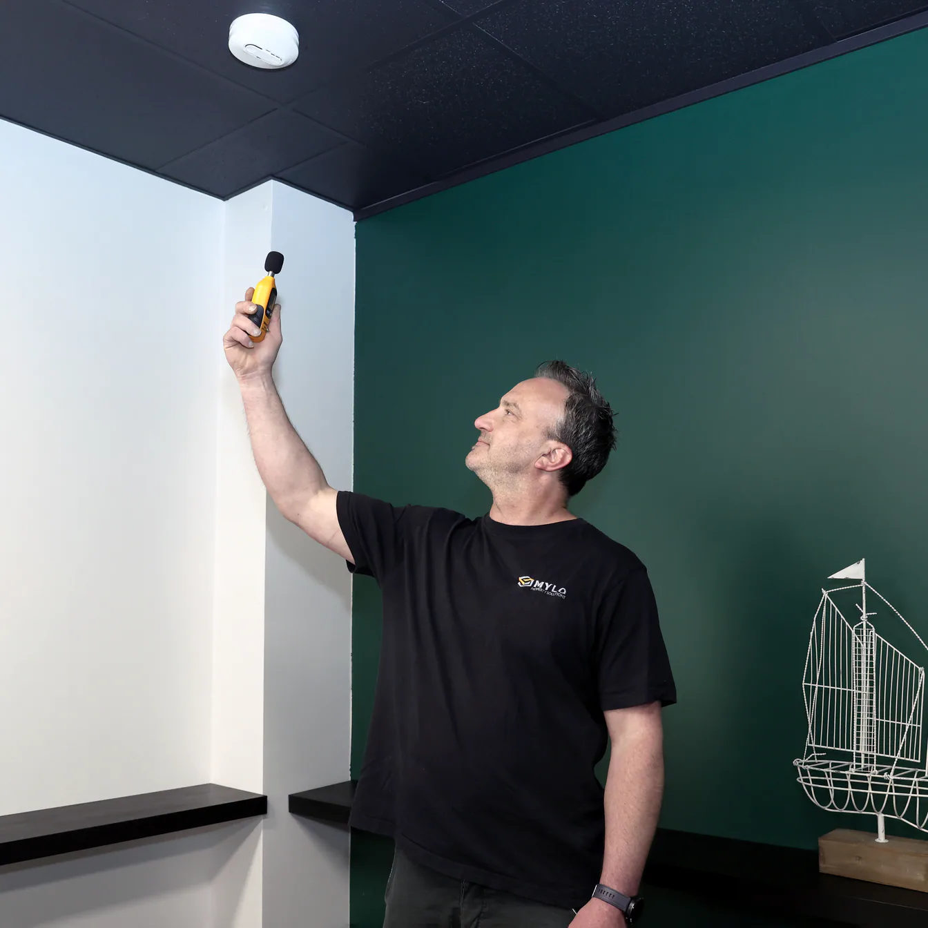 MYLO technician testing a smoke alarm inside a property